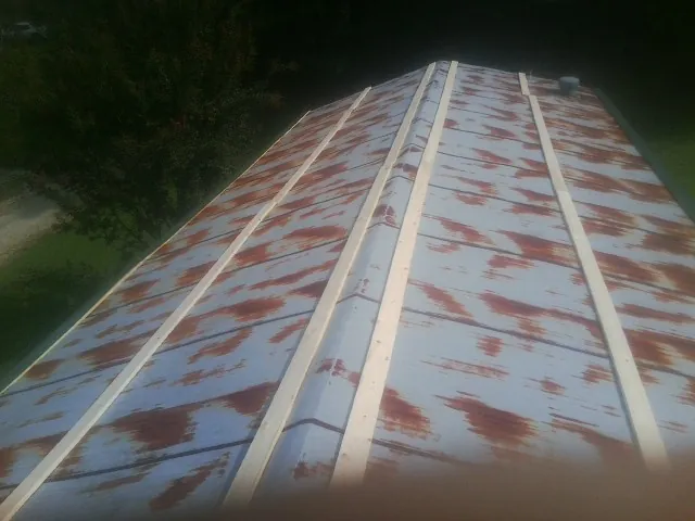 Rusted metal roof panels with new wood purlins before replacement — Storm Damage Roof Repair in Gales Ferry by Roofing Brothers